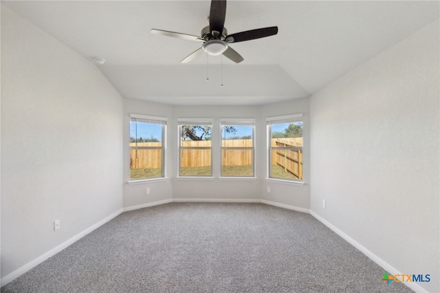 spare room featuring carpet flooring, ceiling fan, and lofted ceiling