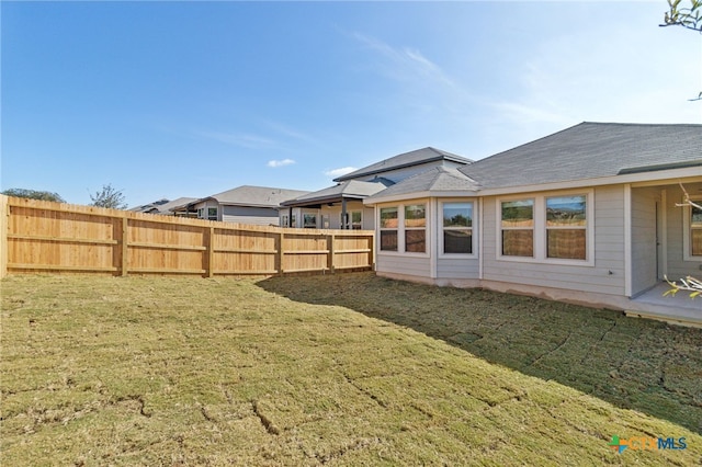 rear view of property with a yard