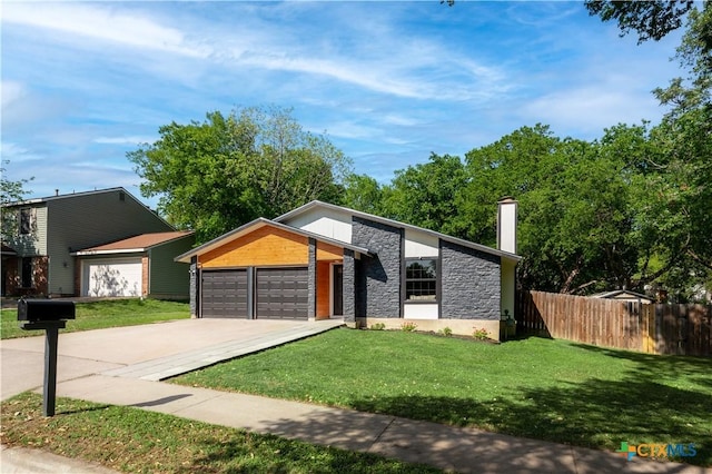 mid-century home with stone siding, a garage, a chimney, and driveway