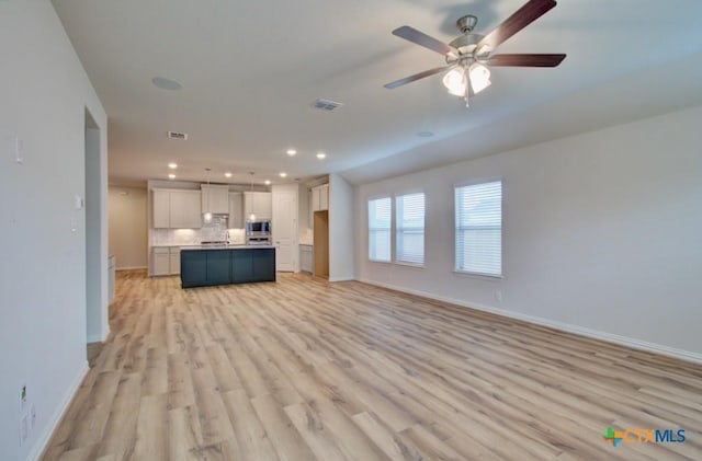 2829 Maximilian Ln, New Braunfels, TX 78130 - unfurnished living room featuring light wood finished floors, recessed lighting, and ceiling fan