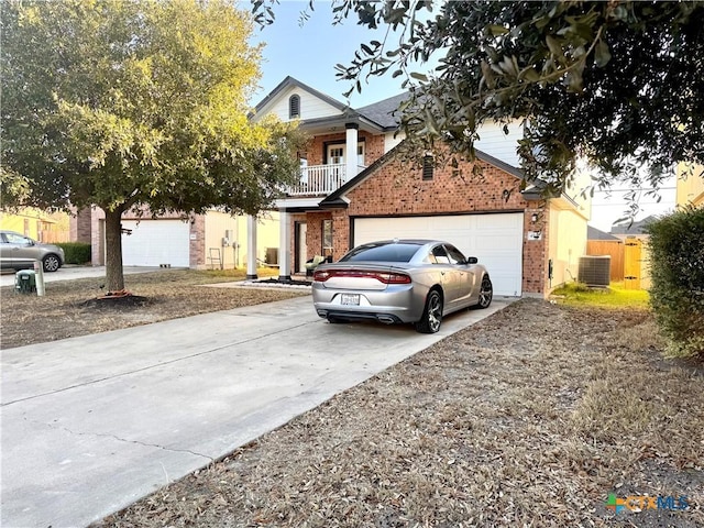 view of front of house with a balcony, central AC, and a garage