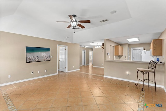 2153 Keystone Dr, New Braunfels, TX 78130 - unfurnished living room with light tile patterned floors, ceiling fan, baseboards, and inlaid floor details