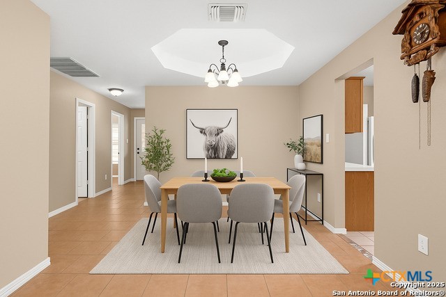 2153 Keystone Dr, New Braunfels, TX 78130 - dining room with light tile patterned floors, a chandelier, and baseboards