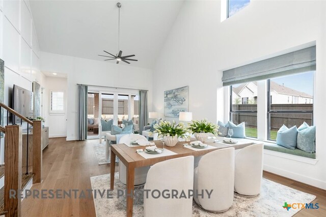 221 Dycus Bnd, Liberty Hill, TX 78642 - dining room with high vaulted ceiling, wood finished floors, a ceiling fan, and baseboards