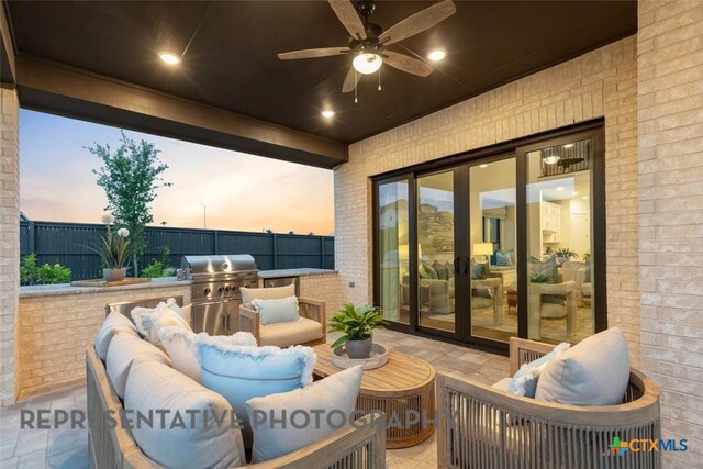 221 Dycus Bnd, Liberty Hill, TX 78642 - patio terrace at dusk with a fenced backyard, ceiling fan, an outdoor living space, and a patio