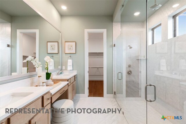 221 Dycus Bnd, Liberty Hill, TX 78642 - bathroom with a stall shower, vanity, a walk in closet, and recessed lighting