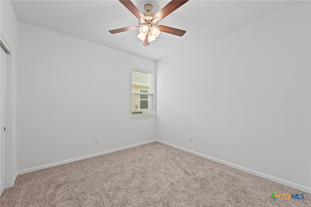 empty room featuring carpet floors and ceiling fan