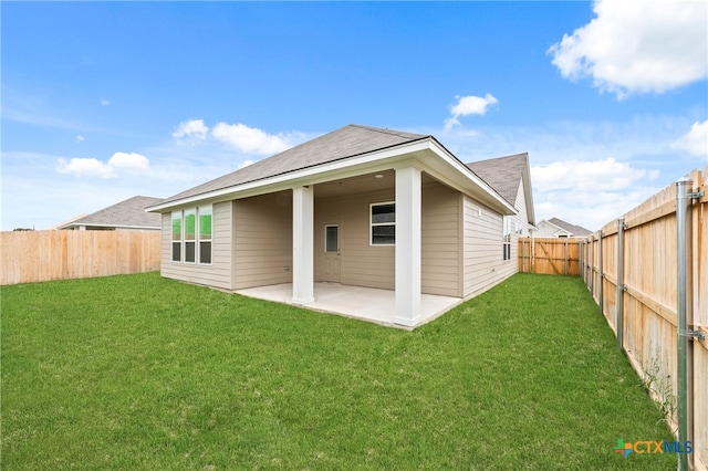 back of property with a patio and a yard