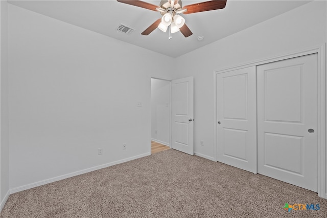 unfurnished bedroom with light carpet, ceiling fan, and a closet