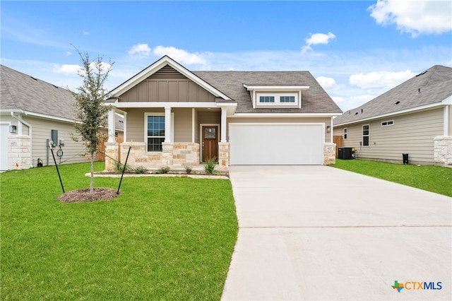 craftsman-style home with a front lawn and central AC unit