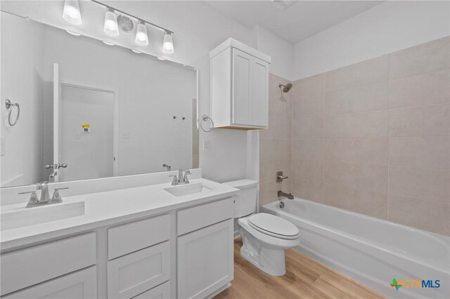 607 Killam Dr, Temple, TX 76502 - bathroom with toilet, wood finished floors, tub / shower combination, and double vanity