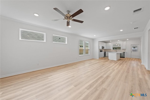 607 Killam Dr, Temple, TX 76502 - unfurnished living room with ceiling fan, baseboards, crown molding, light wood-style flooring, and recessed lighting