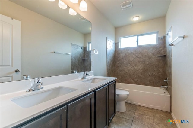 full bathroom with tile patterned floors, vanity, toilet, and tiled shower / bath