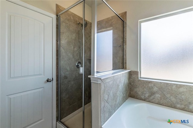 bathroom with shower with separate bathtub