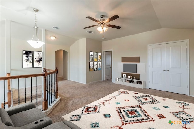 carpeted bedroom featuring a closet and vaulted ceiling