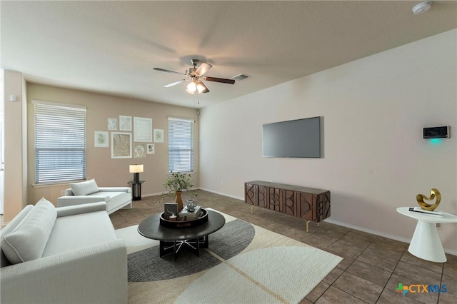 tiled living room featuring ceiling fan