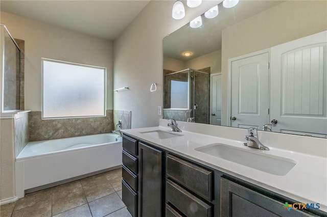 bathroom with tile patterned flooring, vanity, and shower with separate bathtub