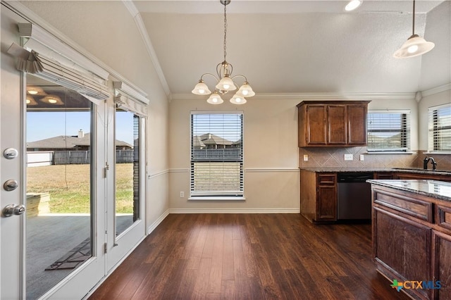 kitchen with dark hardwood / wood-style flooring, decorative light fixtures, crown molding, and dishwasher