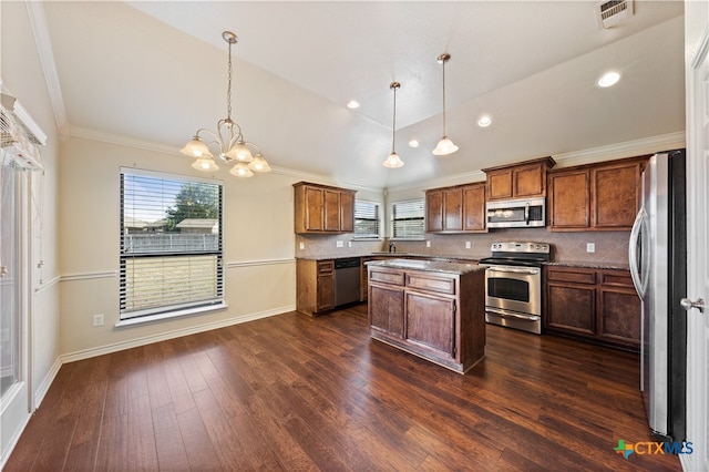 kitchen with a center island, backsplash, an inviting chandelier, hanging light fixtures, and stainless steel appliances