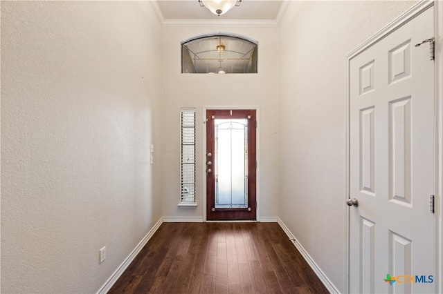 entrance foyer with crown molding and dark hardwood / wood-style flooring