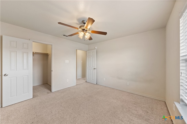 unfurnished bedroom with ceiling fan, a closet, and light carpet