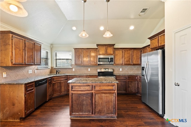 kitchen featuring a center island, sink, stainless steel appliances, dark stone countertops, and lofted ceiling