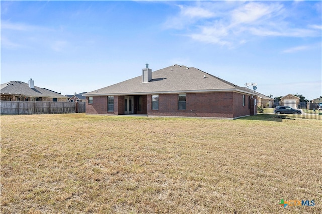 back of property featuring a lawn