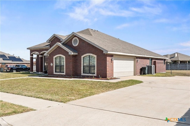 single story home with a garage, a front lawn, and cooling unit