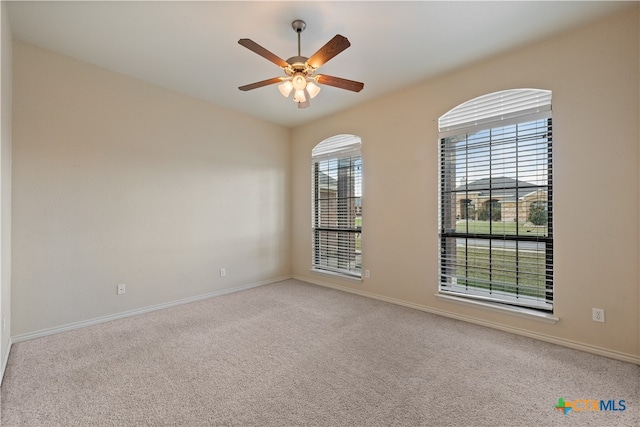 empty room with ceiling fan and carpet floors