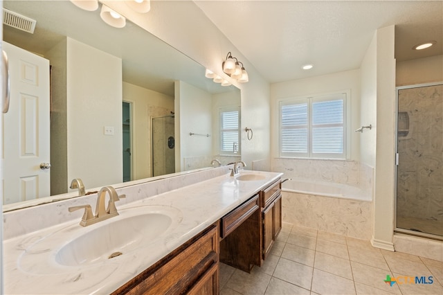 bathroom featuring tile patterned floors, vanity, and separate shower and tub