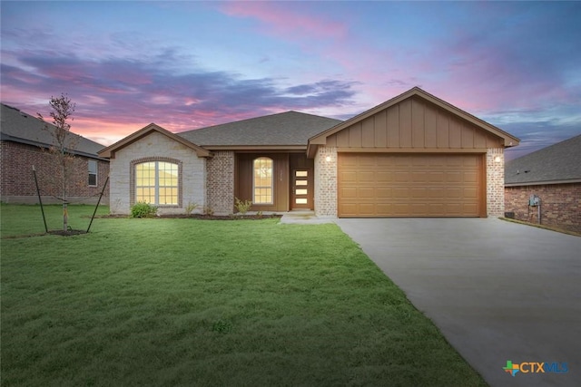 view of front of property with a lawn and a garage