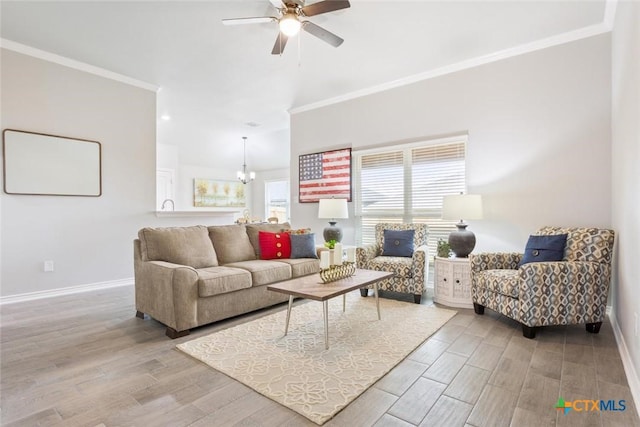 living room featuring ceiling fan with notable chandelier, plenty of natural light, and ornamental molding