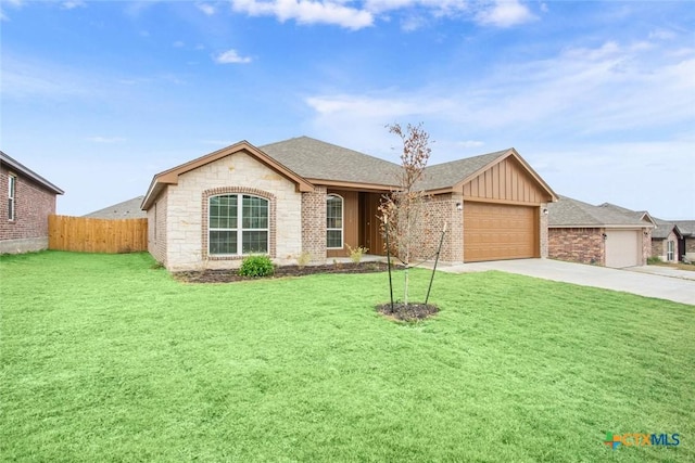 single story home featuring a garage and a front yard