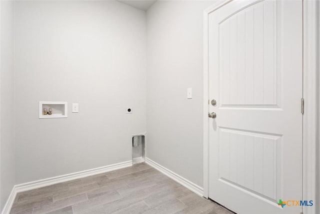 washroom featuring hookup for an electric dryer, hookup for a washing machine, and light hardwood / wood-style flooring