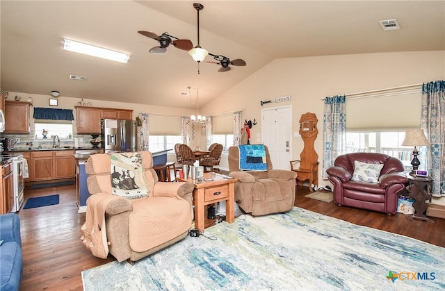 16 Peggy St, Palacios, TX 77465 - living room with ceiling fan with notable chandelier, dark hardwood / wood-style flooring, lofted ceiling, and sink