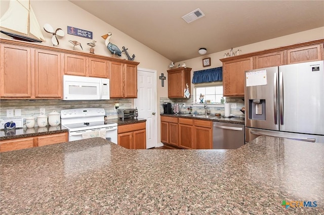 16 Peggy St, Palacios, TX 77465 - kitchen featuring tasteful backsplash, sink, vaulted ceiling, and appliances with stainless steel finishes