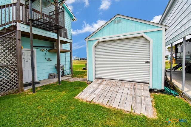 16 Peggy St, Palacios, TX 77465 - garage featuring a lawn
