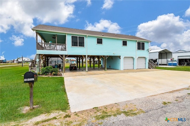 16 Peggy St, Palacios, TX 77465 - view of front of home featuring a carport, a garage, and a front lawn