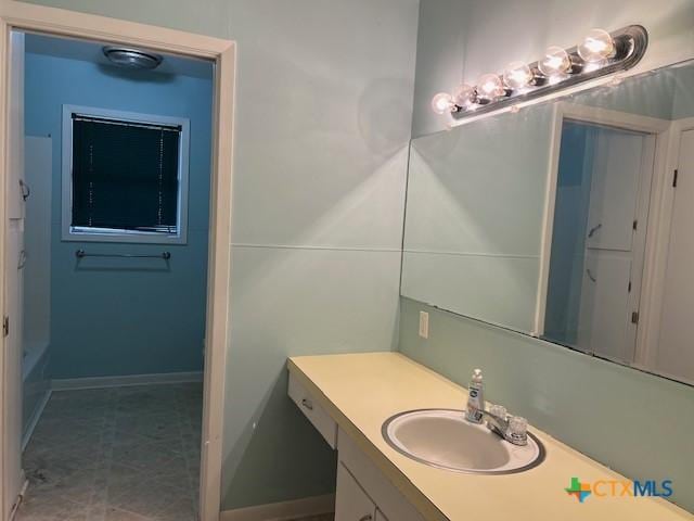 bathroom featuring baseboards and vanity