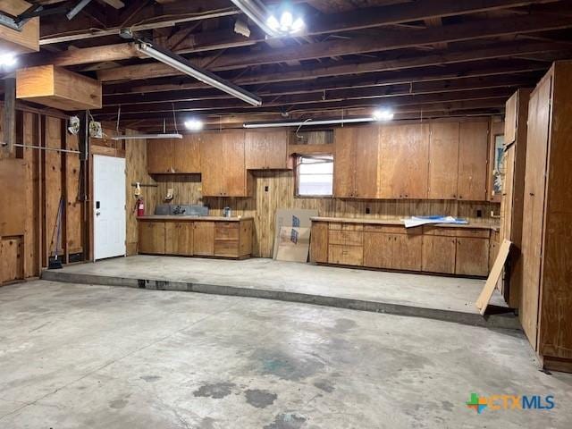 basement featuring wooden walls