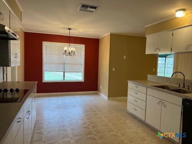 kitchen featuring black electric cooktop, light floors, visible vents, dishwashing machine, and a sink