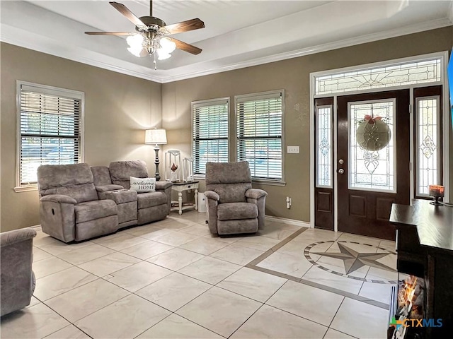 720 E Travis St, Luling, TX 78648 - entrance foyer with light tile patterned floors, a raised ceiling, a ceiling fan, and ornamental molding
