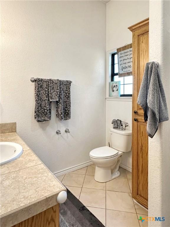 720 E Travis St, Luling, TX 78648 - half bath with vanity and tile patterned flooring