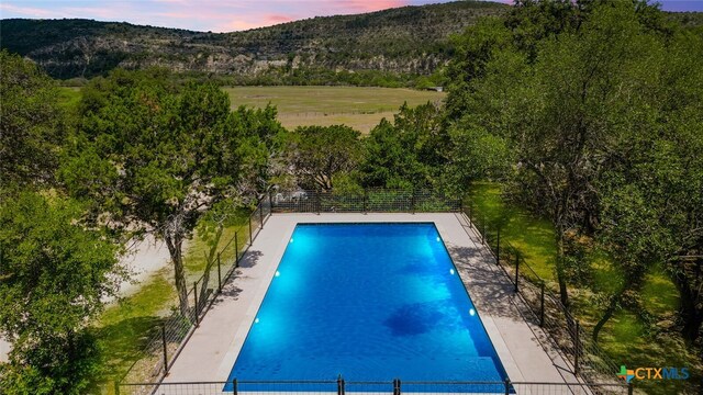 view of pool at dusk