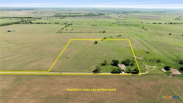 birds eye view of property with a rural view