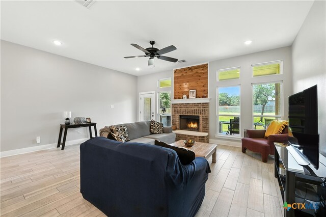 15933 Salado Dr, Temple, TX 76502 - living room with recessed lighting, light wood-style flooring, a brick fireplace, and ceiling fan