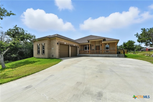 15933 Salado Dr, Temple, TX 76502 - view of front facade with covered porch, an attached garage, a front lawn, driveway, and brick siding