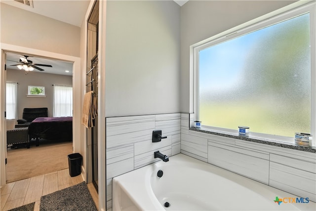15933 Salado Dr, Temple, TX 76502 - bathroom featuring a bath, ensuite bathroom, a ceiling fan, and wood finished floors