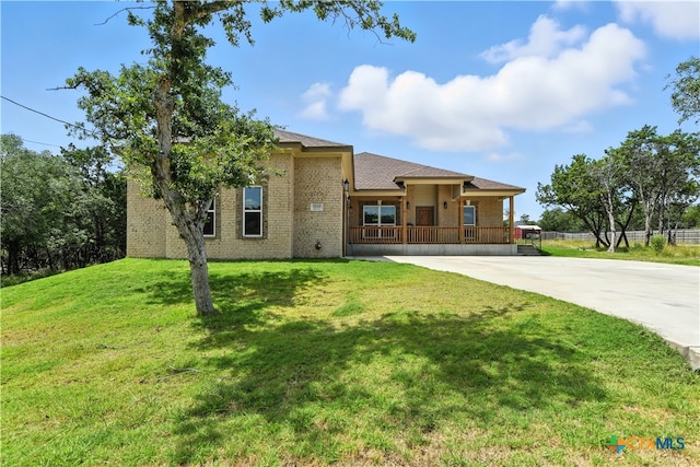 15933 Salado Dr, Temple, TX 76502 - view of front of house with brick siding, covered porch, concrete driveway, and a front lawn