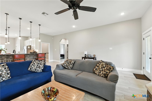 15933 Salado Dr, Temple, TX 76502 - living room featuring arched walkways, light wood-style floors, ceiling fan, and recessed lighting